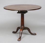 A George III mahogany birdcage tilt top tripod table Of circular form with a turned column,