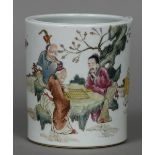 A Chinese porcelain brush pot Decorated with gaming figures seated at a table in a garden,