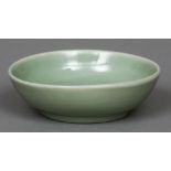 A Chinese celadon porcelain shallow bowl The centre anhua decorated with a floral spray,