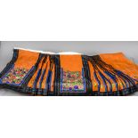 A late 19th/early 20th century Chinese pleated skirt The orange ground with embroidered floral