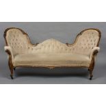 A Victorian walnut framed double spoon back settee Of typical form,