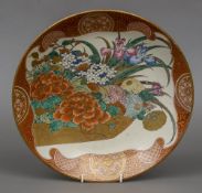 A late 19th century Japanese charger Decorated in the Kutani manner, centred with floral sprays,