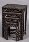 A late 19th century Chinese carved wooden quartetto nest of tables Each top decorated with a dragon.