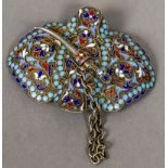 A Russian enamel decorated silver buckle With floral scrollwork ground,