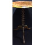 A burr elm top wine table The circular top on a barley twist column, with three outswept legs.