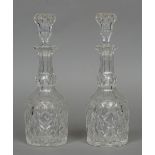 A pair of large cut glass decanters Each of mallet form, with an elongated neck and stopper.