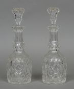 A pair of large cut glass decanters Each of mallet form, with an elongated neck and stopper.