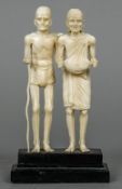 A late 19th century Indian ivory figural group Formed as elderly beggars,