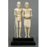 A late 19th century Indian ivory figural group Formed as elderly beggars,