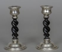 A pair of George V silver mounted ebonised candlesticks, hallmarked Chester 1930,