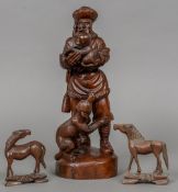 A 19th/20th century Chinese wood carved figure of a Mongolian huntsman Holding a fawn,