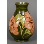A Walter Moorcroft pottery baluster vase Decorated with the Peach Hibiscus pattern,