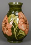 A Walter Moorcroft pottery baluster vase Decorated with the Peach Hibiscus pattern,