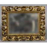 A 19th century Italian carved giltwood framed mirror Of pierced scrolling floral form. 46.