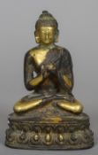 A gilt bronze figure of Buddha Typically modelled, seated in the lotus position. 15.5 cm high.