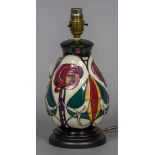 A modern Moorcroft pottery table lamp Decorated with birds amongst stylised flowers. 28 cm high.