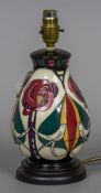 A modern Moorcroft pottery table lamp Decorated with birds amongst stylised flowers. 28 cm high.