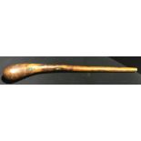 A wooden club The bulbous end opposing a brass ferrule at the other. 80 cm long.