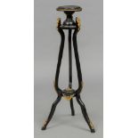 A 19th century Continental ormolu mounted ebonised torchere The circular top above three rams mask