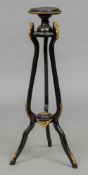 A 19th century Continental ormolu mounted ebonised torchere The circular top above three rams mask