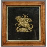 A 19th century gilt metal plaque Worked as St. George slaying the dragon, maple framed and glazed.
