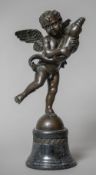 A bronze model of a cherub holding a dolphin Mounted on a spreading plinth base. 39 cm high.