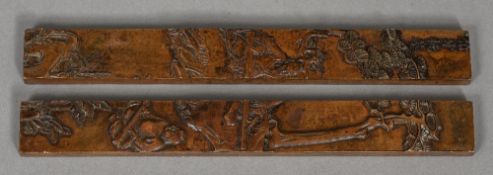 A pair of Chinese patinated bronze scroll weights Decorated with figures amongst woodland,