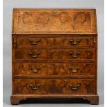 An 18th century burr walnut bureau The feather banded fall enclosing a fitted interior above four