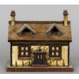 A Victorian painted tea caddy Formed as a cottage. 23 cm wide.