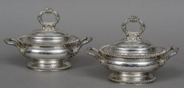 A pair of silver plated twin handled tureens and covers Each with gadrooned rim and scroll handle,