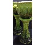 A pair of Soudan ware green glaze majolica jardinieres on stands Each with foliate and scroll