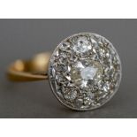 A diamond set 18 ct gold cluster ring The central stone pear shaped.