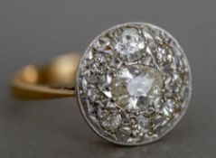 A diamond set 18 ct gold cluster ring The central stone pear shaped.