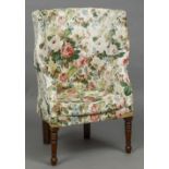 A 19th century porter's wingback armchair Of typical high backed form,