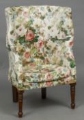 A 19th century porter's wingback armchair Of typical high backed form,