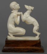An Art Deco carved ivory group Formed as a nude girl and a greyhound,