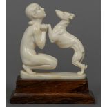 An Art Deco carved ivory group Formed as a nude girl and a greyhound,