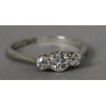 A diamond set 18 ct white gold three stone ring The centre stone approximately 0.40 carat.