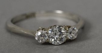 A diamond set 18 ct white gold three stone ring The centre stone approximately 0.40 carat.