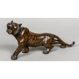 A Japanese Meiji period cold painted patinated bronze model of a tiger Naturalistically modelled on