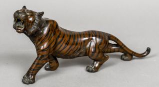 A Japanese Meiji period cold painted patinated bronze model of a tiger Naturalistically modelled on