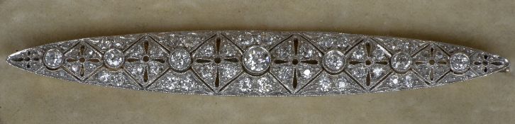 An Art Deco unmarked gold and platinum diamond set brooch Of pierced navette form. 8 cm wide.