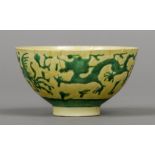 A Chinese Imperial yellow ground bowl Decorated in the round with green dragons and phoenix,