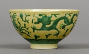 A Chinese Imperial yellow ground bowl Decorated in the round with green dragons and phoenix,