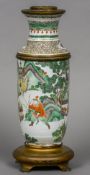 A 19th century Chinese famille verte oil lamp Decorated in the round with warriors and with gilt