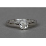 An 18 ct white gold diamond solitaire ring The claw set stone approximately 0.65 carat.