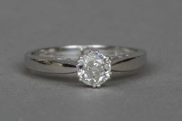 An 18 ct white gold diamond solitaire ring The claw set stone approximately 0.65 carat.