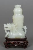 A small Chinese jade vase Formed as mythical beast, mounted on a detachable hardwood stand. 12.