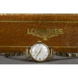 A 9 ct gold ladies Longines wristwatch The white dial with Arabic numerals and batons. 2.5 cm wide.