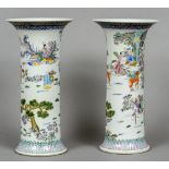 A pair of Chinese porcelain vases Each decorated with figures and deer in a continuous landscape,